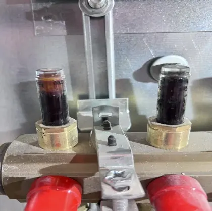 Detail dvou průtokoměrů plných tmavé kalné vody